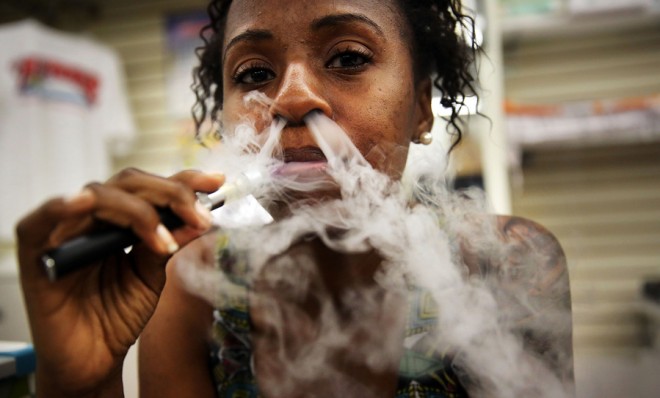 a-customer-smokes-an-electronic-cigarette-at-vape-new-york-a-dedicated-vaporized-nicotine-retailer